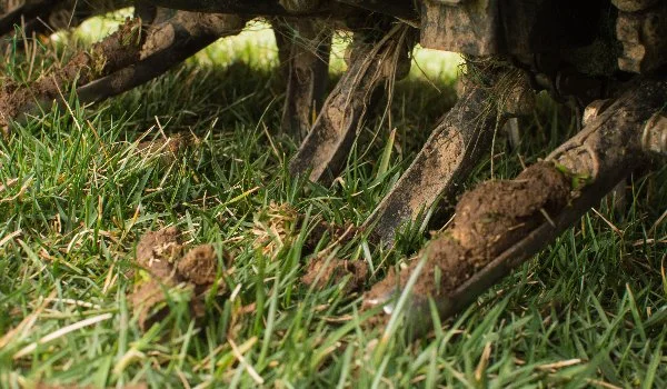 Lawn aeration with machinery close-up in Ada, MI.